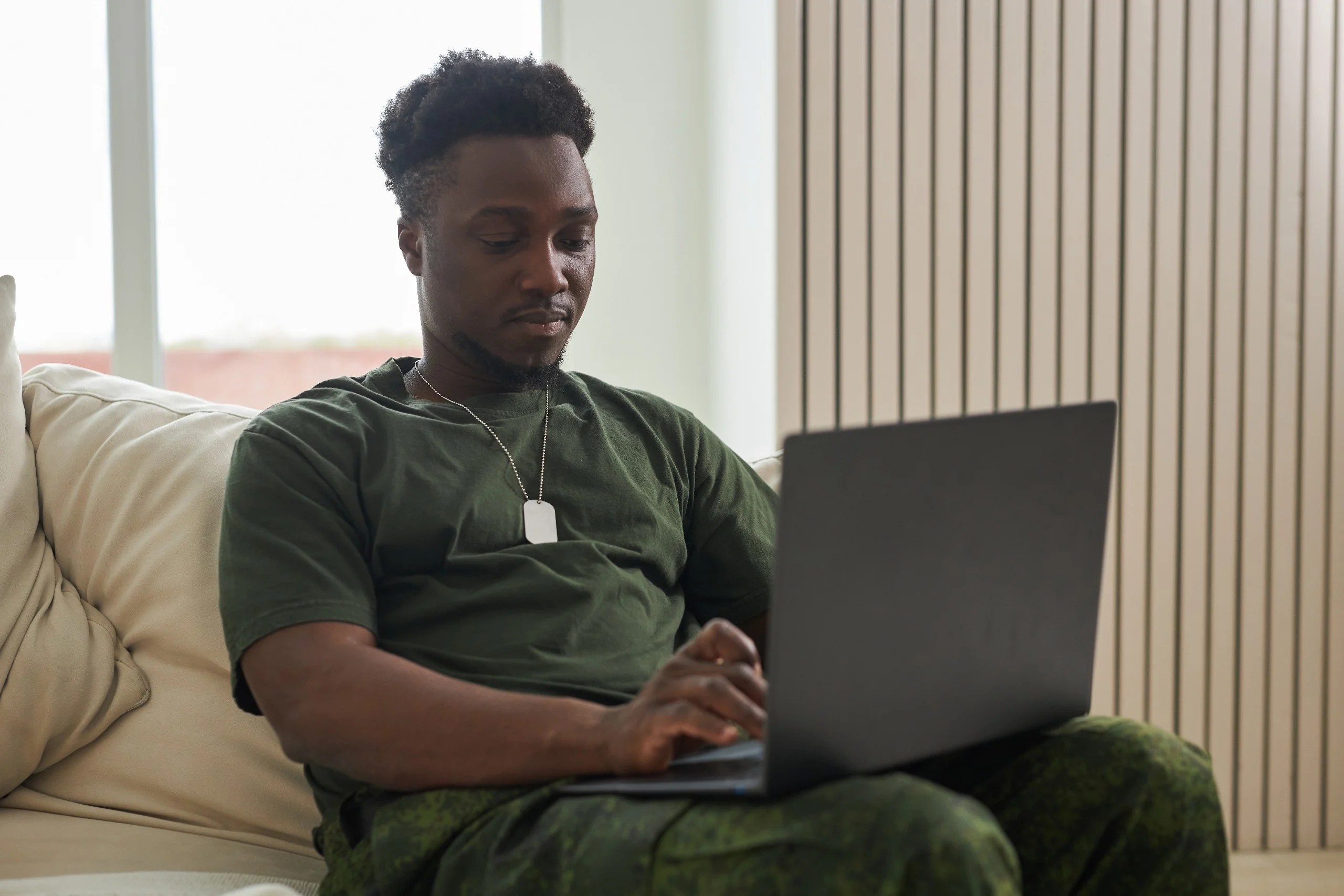 Military man on laptop.